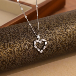 Elegant silver heart necklace with rectangular cubic zirconia on textured wood