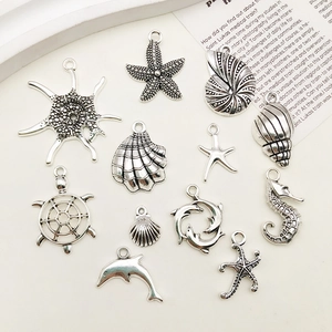 Detail of silver alloy ocean charms including starfish, seashells and dolphins for DIY jewelry