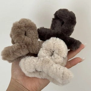 Three plush faux fur claw clips in dark brown, light coffee, and cream white set