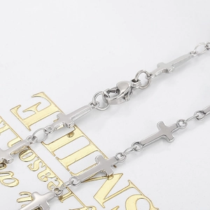 Macro shot of silver stainless steel cross link chain necklace with lobster clasp