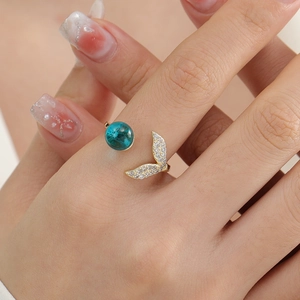 Elegant gold fishtail open ring with deep blue bead and zircon accents for women