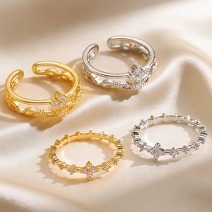 Detail view of gold and silver ring set with zircon accents on champagne satin fabric