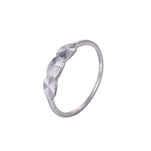 Macro detail of a silver ring featuring three connected sunburst circular patterns on white