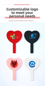 Detailed view of four heart-shaped handheld mirrors in red, black, pink, and white