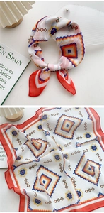 Detail view of cotton linen square scarf with geometric print and red stitched edges