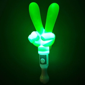 Close-up of green glowing V-shaped LED hand gesture wand with white plastic handle