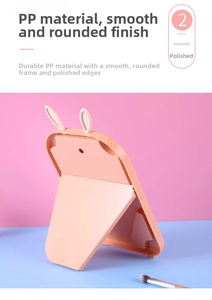 Detail of pink rabbit ear makeup mirror showing the stable triangular folding stand