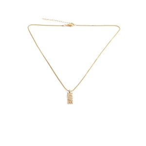 Close-up of golden necklace with vertical LOVE pendant inlaid with zircon crystals