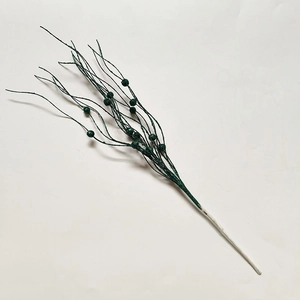 Detail of dark green Christmas decorative branch with sparkling glitter and ball tips