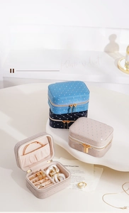Detail of plush velvet jewelry box featuring diamond quilting and interior ring slots
