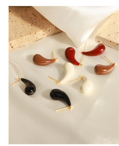 Detailed view of colorful drop-shaped earrings with glossy enamel finish and gold pins