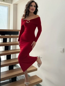 Detail of red off-shoulder velvet dress with a silver metal buckle and ruching detail