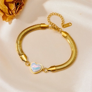 Macro view of gold stainless steel snake chain with a radiant heart-shaped charm