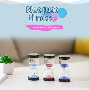 Detailed view of colorful 1-minute sandglass timers with black caps on a wooden table