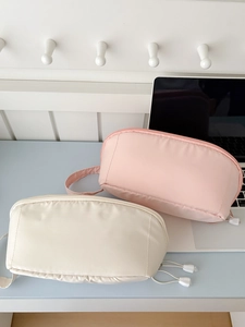 Minimalist macaron-colored large makeup bags in pink and cream with side handles