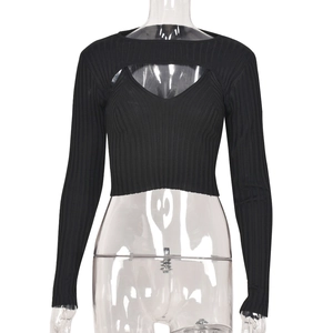 Detail of black ribbed knit long sleeve crop top with a layered camisole design