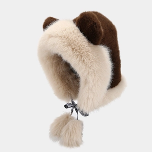 Detail of plush faux rabbit fur hat featuring cute ears and fuzzy pompom drawstrings