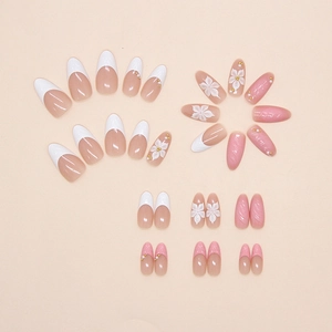 Detailed view of floral pearl French press-on nails with 3D flower and pink wave designs