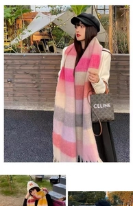 Detail of colorful plaid scarf with soft fringe texture worn in a cozy outdoor setting