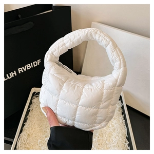 Macro detail of white quilted bubble handbag with soft puff texture and zipper
