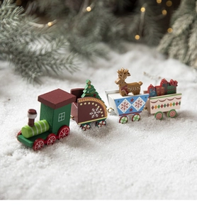 Christmas wooden painted toy train with tree and reindeer decor on artificial snow