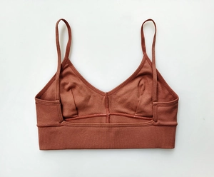 Flat lay macro view of the back design on this ribbed cotton brown red sports bra