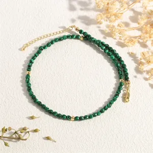 Detail shot of green malachite beaded necklace with gold spacers and lobster clasp