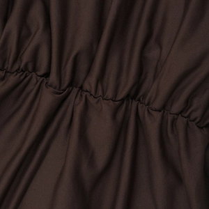 Dettaglio delle increspature in rete marrone caffè e trama a maglia su abito a vita alta