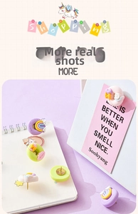 Detail of cute macaron resin push pins in rainbow and donut shapes on a notebook