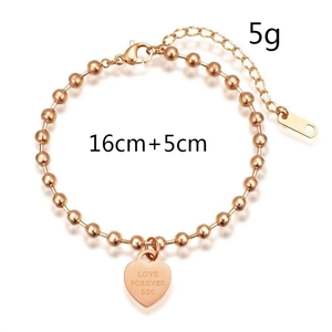 Detailed macro view of a rose gold heart charm bracelet with Love Forever 520 engraving