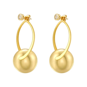 Detailed macro of gold-plated spherical earrings with zircon studs and oval links