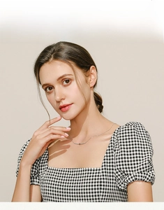 Close-up of minimalist S925 sterling silver star necklace worn by a model for styling