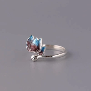 Detail of enamel lotus flower on silver ring with brushed texture and adjustable band