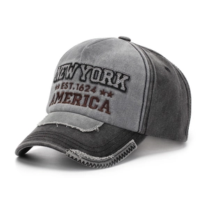 Macro view of vintage New York 1624 embroidery and distressed brim on patchwork baseball cap