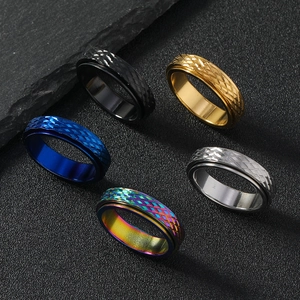 Close-up of 6mm spinner rings with mesh texture in black gold blue silver and rainbow steel