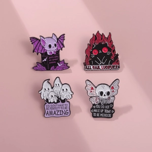 Detail of four gothic enamel pins featuring ghost, bat, and cat on a pink background