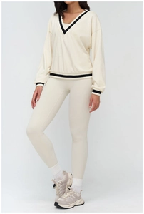 Detail of V-neck activewear sweatshirt with striped cuffs and cream fabric texture