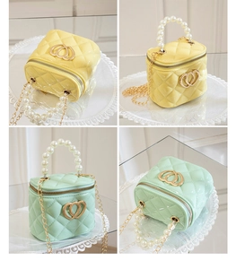 Detailed view of mini jelly bags with double heart accents and pearl handles in yellow and green