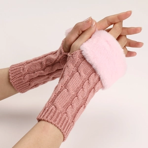 Close-up of pink cable knit arm warmers with plush faux fur trim on the wrist cuffs