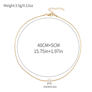 Minimalist gold snake chain necklace with single pearl pendant on white background