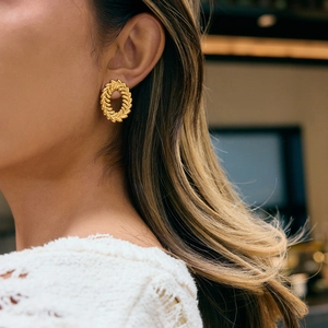 Elegance 18K gold plated leaf wreath stud earrings worn by model in soft lighting