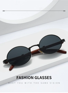 Detail view of vintage oval sunglasses with wood grain temples on minimalist white steps