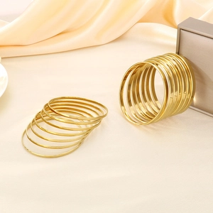 Set of stackable gold-plated titanium steel bangles with a high-polished mirror finish