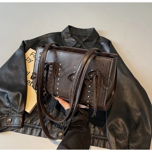 Dark brown PU leather tote bag with rivet accents and bow details in a retro punk style