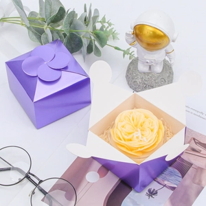 Purple pearl-finished gift box with clover-shaped seal and yellow rose soap detail