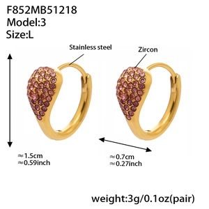 Detail view of heart-shaped stainless steel earrings with pink zircon and gold plating