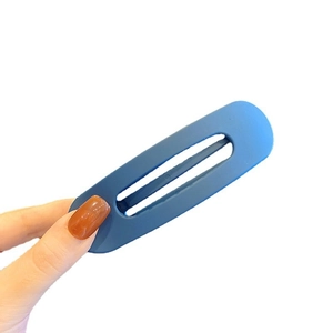 Matte Klein blue large hair clip for women, minimalist oval hair accessory in hand