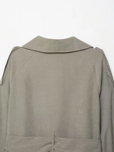 Detail view of sage green suede jacket back showing lapel stitching and yoke texture