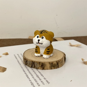 Close-up of hand-carved wooden tiger figurine with artisanal chisel marks on wood base
