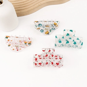 Set of four transparent Christmas hair claws featuring festive gingerbread and tree patterns
